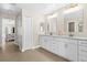 Bright bathroom featuring double vanity with modern fixtures and access to the main bedroom at 3528 Monday Ter, North Port, FL 34286