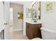 Second bathroom with wood vanity and modern black faucet at 3528 Monday Ter, North Port, FL 34286