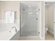 Bathroom featuring a glass enclosed shower and separate tub at 3528 Monday Ter, North Port, FL 34286
