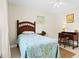 Charming bedroom featuring a twin bed, ceiling fan, and a quaint writing desk at 3528 Monday Ter, North Port, FL 34286