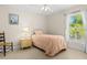 Well-lit bedroom with neutral walls, ceiling fan, and bright window at 3528 Monday Ter, North Port, FL 34286