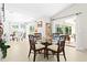 Bright dining area featuring modern decor, a glass table and access to the lanai at 3528 Monday Ter, North Port, FL 34286