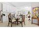 Bright dining area featuring modern decor, a glass table and access to the living area at 3528 Monday Ter, North Port, FL 34286