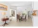 Bright dining area featuring modern decor, a glass table, and access to the kitchen and living areas at 3528 Monday Ter, North Port, FL 34286