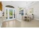 Elegant dining area with chandelier, beautiful tile floors, and front door view at 3528 Monday Ter, North Port, FL 34286