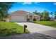 Lovely home featuring a manicured lawn, extended driveway, and attached two-car garage at 3528 Monday Ter, North Port, FL 34286