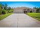 A well-maintained home featuring a spacious driveway, landscaped yard, and a two-car garage at 3528 Monday Ter, North Port, FL 34286