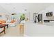 Modern kitchen with a breakfast bar overlooking the living area, stainless appliances, and stylish lighting at 3528 Monday Ter, North Port, FL 34286