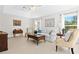 Spacious living room with cozy seating, a ceiling fan, and plenty of natural light at 3528 Monday Ter, North Port, FL 34286