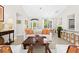 Open-concept living area with tile flooring, a white sofa, and view to the kitchen at 3528 Monday Ter, North Port, FL 34286
