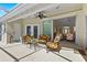 Covered patio offers outdoor seating and leads into a home's interior at 3528 Monday Ter, North Port, FL 34286