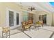 Covered patio has stylish seating and access to the home's open living space at 3528 Monday Ter, North Port, FL 34286