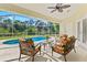 Inviting screened-in pool patio area featuring comfortable seating and views of the refreshing pool and the serene backyard at 3528 Monday Ter, North Port, FL 34286