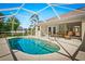 Screened-in pool area with seating, clear blue water, and a spacious deck at 3528 Monday Ter, North Port, FL 34286