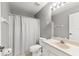Cozy bathroom featuring a white shower curtain, toilet, sink, and a well-lit mirror at 3605 60Th W St, Bradenton, FL 34209