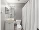 Small bathroom with a shower curtain and a white toilet, sink, and vanity at 3605 60Th W St, Bradenton, FL 34209