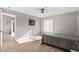 Bright bedroom with wood floors, gray walls, ceiling fan, and a doorway leading to another room at 3605 60Th W St, Bradenton, FL 34209