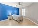 Spacious bedroom with blue walls, wood floors, featuring essential furnishings and natural light at 3605 60Th W St, Bradenton, FL 34209