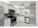 Well-lit kitchen features stainless steel appliances, white cabinets, and an open layout at 3605 60Th W St, Bradenton, FL 34209