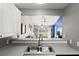Bright kitchen with stainless steel sink overlooking the open-concept living area at 3605 60Th W St, Bradenton, FL 34209