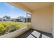 Enclosed lanai with a view of the lush greenery and nearby homes at 3605 60Th W St, Bradenton, FL 34209
