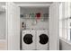 Laundry closet with side-by-side washer and dryer units and wire shelving for storage at 3605 60Th W St, Bradenton, FL 34209