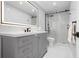 Sleek bathroom with modern gray vanity, illuminated mirror, and glass-enclosed shower at 3875 Catalina Dr, Bradenton, FL 34210