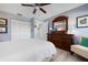 Inviting bedroom with a classic dresser, ceiling fan, and comfortable chair at 3875 Catalina Dr, Bradenton, FL 34210