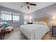 Cozy bedroom with natural light, ceiling fan, and a comfortable reading nook at 3875 Catalina Dr, Bradenton, FL 34210