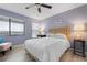 Bright bedroom with a large window, ceiling fan, and stylish wood-look flooring at 3875 Catalina Dr, Bradenton, FL 34210
