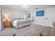 Bedroom featuring light gray walls, wood floors, and ensuite bathroom at 3875 Catalina Dr, Bradenton, FL 34210