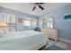 Bedroom with light blue walls, ceiling fan and light wood flooring at 3875 Catalina Dr, Bradenton, FL 34210