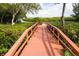 Scenic views along a wooden pier surrounded by lush greenery and serene waterways at 3875 Catalina Dr, Bradenton, FL 34210