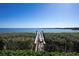 Picturesque wooden dock extending into the calm blue water, surrounded by lush greenery at 3875 Catalina Dr, Bradenton, FL 34210