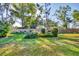 Secluded backyard featuring a lush green lawn, manicured landscaping and wooden privacy fence at 4058 Oakhurst Dr # 3174, Sarasota, FL 34233