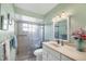 Bathroom with a glass-enclosed shower and a vanity with fresh flowers at 4058 Oakhurst Dr # 3174, Sarasota, FL 34233