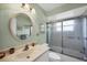 Well-lit bathroom featuring a round mirror, modern fixtures and shower with sliding glass doors at 4058 Oakhurst Dr # 3174, Sarasota, FL 34233