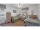 Bright bedroom with two twin beds, floral décor, and a window with outdoor views at 4058 Oakhurst Dr # 3174, Sarasota, FL 34233
