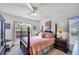Charming bedroom with a four-poster bed, soft lighting, and a large window at 4058 Oakhurst Dr # 3174, Sarasota, FL 34233