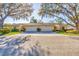 Exterior view of charming side-by-side homes with mature trees and a well-kept lawn at 4058 Oakhurst Dr # 3174, Sarasota, FL 34233
