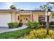 Charming home featuring a well-manicured yard, front door wreath, and American flag at 4058 Oakhurst Dr # 3174, Sarasota, FL 34233