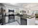 Well-maintained kitchen with stainless steel appliances, granite countertops, and white cabinetry at 4058 Oakhurst Dr # 3174, Sarasota, FL 34233