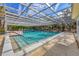 Community pool with a screened enclosure, tiled deck and comfortable seating for residents at 4058 Oakhurst Dr # 3174, Sarasota, FL 34233
