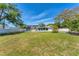 Spacious backyard with well-maintained lawn, solar panels, enclosed patio, and privacy fencing at 436 Parkview Dr, Sarasota, FL 34243