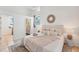 Serene bedroom with plush bedding, a decorative mirror, and an ensuite bathroom for added convenience and style at 436 Parkview Dr, Sarasota, FL 34243