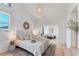 Bright bedroom featuring neutral decor, a modern light fixture, and seamless access to a cozy sitting area at 436 Parkview Dr, Sarasota, FL 34243