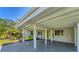 View of the carport with updated siding and a pop of color at the front door at 436 Parkview Dr, Sarasota, FL 34243
