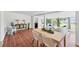 Dining area with a large wooden table, terracotta tile flooring and views of backyard at 436 Parkview Dr, Sarasota, FL 34243
