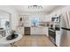 Bright kitchen with stainless steel appliances, white cabinets, and modern fixtures at 436 Parkview Dr, Sarasota, FL 34243