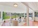 Sunroom featuring tiled floors, ample natural light, and a comfortable seating area, creating a tranquil space at 436 Parkview Dr, Sarasota, FL 34243